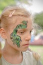 Smiling girl with face painting of peacock