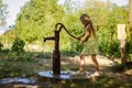 Little child pumping water from the water well Royalty Free Stock Photo