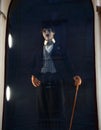 Little Man Charlie. Wax figure of Sir Charles Spencer Chaplin in the famous film image in a dark window