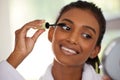 A little mascara makes a big difference. a beautiful young woman going through her makeup routine at home.