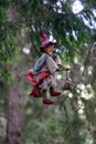 Little mascot witch puppet hanging in tree Royalty Free Stock Photo
