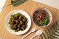 Little meatballs with green chili sauce in a plate and gravy in a bowl