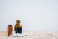 Little medicine bottles and many white tablets on a wooden table Royalty Free Stock Photo