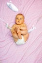 Little mesmerized baby girl lay on pink blanket Royalty Free Stock Photo