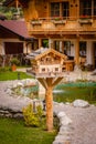 Little miniature bird house with many details designed like a apartment lodge in the alps