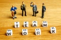 Little miniature figurines with little dices forming word team work as a part of team meeting collection pictures