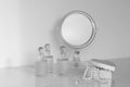 Little mirror on a dresser rounded with fragrance bottles and casket