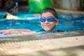 Little mix Asian Arab boy swimming at swimming pool outdoor activity Royalty Free Stock Photo