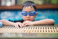 Little mix Asian Arab boy swimming at swimming pool outdoor activity