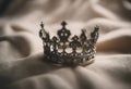 Little model crown placed on a linen canvas