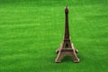 Little model Eiffel Tower on grass