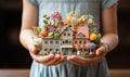 Little model house in the hands of a woman. Concept of real estate.