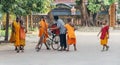 Little monks gathering around an ice cream man.