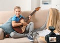 Little music teacher recording guitar lesson