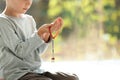 Little Muslim boy with misbaha praying indoors, closeup