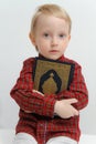 Little muslim European boy with islamic holy book Quran or Kuran