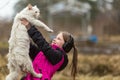 A little naughty girl in headphones playing with the cat. Nature.