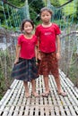 Little Nepalese girls on rope hunging suspension bridge