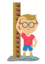 Little nerd boy with glasses measuring his height Royalty Free Stock Photo