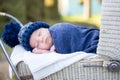 Little newborn baby boy, sleeping in old retro stroller in fores Royalty Free Stock Photo