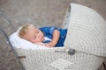 Little newborn baby boy, sleeping in old retro stroller in fores Royalty Free Stock Photo
