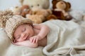 Little newborn baby boy, sleeping with teddy bear at home in bed Royalty Free Stock Photo