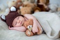 Little newborn baby boy, sleeping with teddy bear at home in bed Royalty Free Stock Photo
