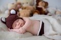 Little newborn baby boy, sleeping with teddy bear at home in bed Royalty Free Stock Photo