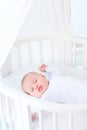 Little newborn baby boy sleeping in white round crib Royalty Free Stock Photo