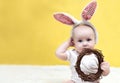 Little newborn baby with bunny ears for easter, Portrait a cute baby dressed in Easter bunny ears with eggs