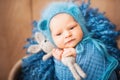 Little newborn baby with a hare closeup and copy space. Newborn photo in a blue diaper. Royalty Free Stock Photo