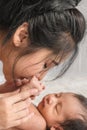 Little newborn infant baby lying on bed with mother holding hand Royalty Free Stock Photo