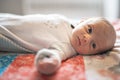 A Little Newborn relaxing on the parent bed Royalty Free Stock Photo