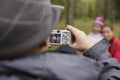 Little offspring shooting his family in park Royalty Free Stock Photo