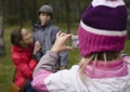 Little offspring shooting his family in park Royalty Free Stock Photo