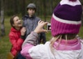 Little offspring shooting his family in park Royalty Free Stock Photo