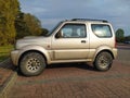 Old grey silver Suzuki Jimny 4wd car with two doors parked