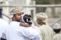 Little Omani girl isleeping on a shoulder of her daddy