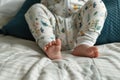 little one in a sleepsuit with feet playing Royalty Free Stock Photo