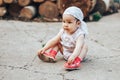 Little one year old girl with dark hair play on yard at home. half-breed girl father is kazakh mother russian caucasian