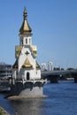 Little orthodox chapel on the river bank, bridge over the river, church on the water