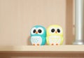 little owls figurines on a bookshelf. siblings concept. twins children. family relationship and connection. friendship