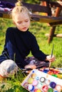 Little painter at work near waterfall Royalty Free Stock Photo