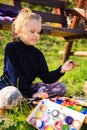 Little painter at work near waterfall Royalty Free Stock Photo