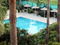 A little paradise. Top view of the courtyard garden of the resort hotel with a small pool surrounded by tropical plants Royalty Free Stock Photo