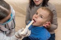 Little patient showing his throat to pediatrician Royalty Free Stock Photo