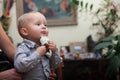 Little pensive baby boy with table napkin indoor Royalty Free Stock Photo