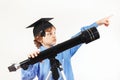 Little pensive boy in academic hat with telescope on white background Royalty Free Stock Photo