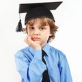 Little pensive boy in academic hat on white background Royalty Free Stock Photo