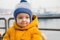 Little pensive boy walks in the city